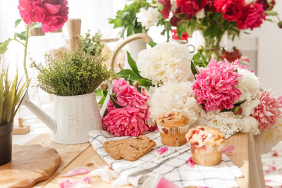 The kitchen countertop is decorated with peonies. 