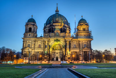 The illuminated berlin carhedral, germany, just before sunrise