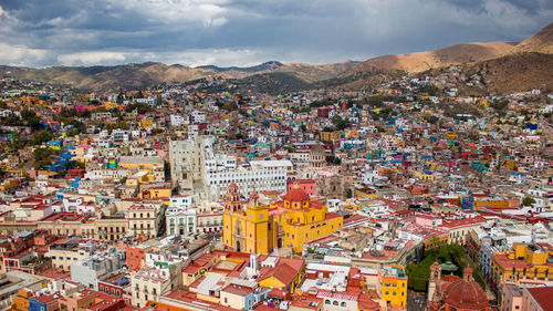 High angle view of city against cloudy sky