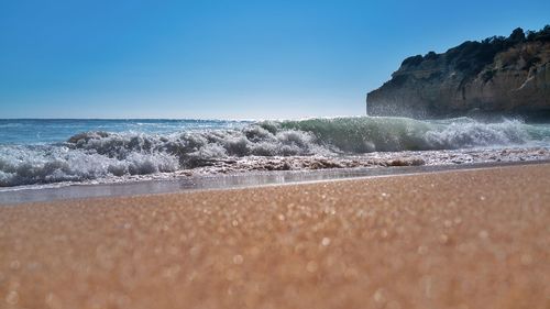 Surface level of sea against clear sky