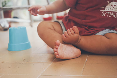 Low section of father and boy lying on floor