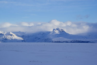 Scenic view of snowcapped mountains against sky