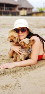 Portrait of young woman lying on sand