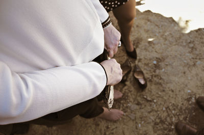 Midsection of man and woman standing on land