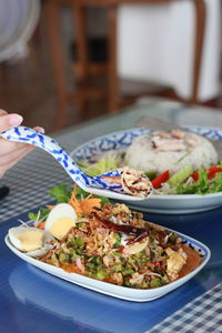 High angle view of hand holding thai food