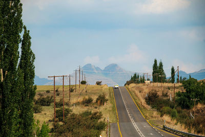 Panoramic view of road by landscape against sky