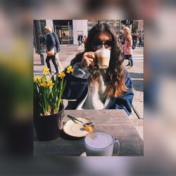 Woman photographing with camera on table