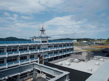 High angle view of buildings by sea against sky