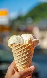 Close-up of hand holding ice cream cone