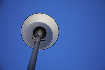 Low angle view of street light against blue sky