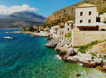 Scenic view of sea and buildings against sky