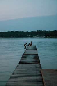 Pier over lake against sky