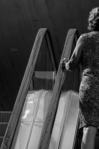 Woman sitting on escalator