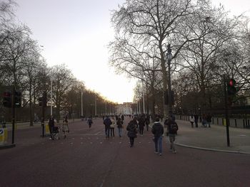 People on road in city against clear sky