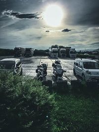 Cars on field against sky