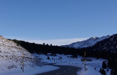 Scenic view of snowcapped mountains against clear blue sky