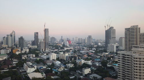 Aerial view of modern buildings in city against clear sky