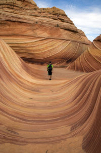 Man standing on rock formations in arizona