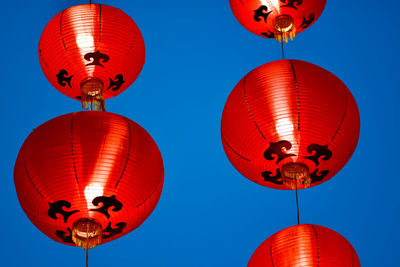 Low angle view of lanterns hanging against clear sky