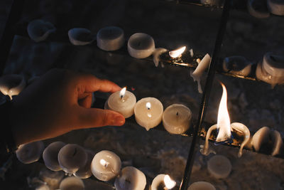 Close-up of hand holding candles