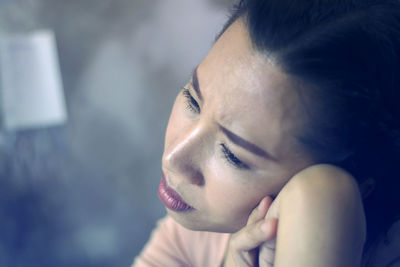 Close-up portrait of a young woman looking away