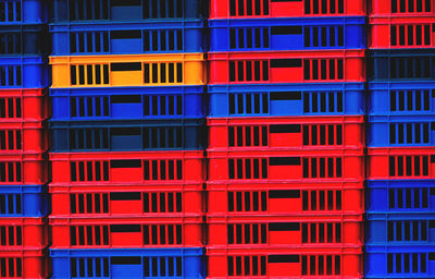 Full frame shot of red and blue crates for sale at market