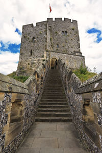 Low angle view of fort against cloudy sky