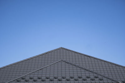 Low angle view of building against clear blue sky