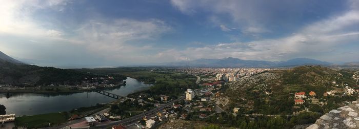 High angle view of cityscape against cloudy sky