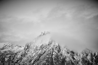 Low angle view of snowcapped mountain against sky