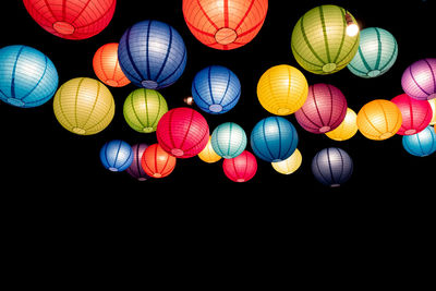 Low angle view of illuminated lanterns hanging at night