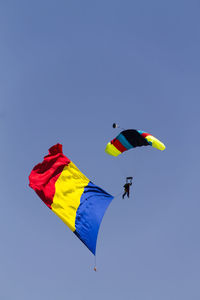 Low angle view of flag against blue sky