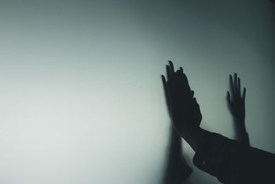 Cropped image of hand over black background