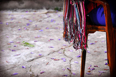 Close-up of tassels from scarf of person sitting on chair