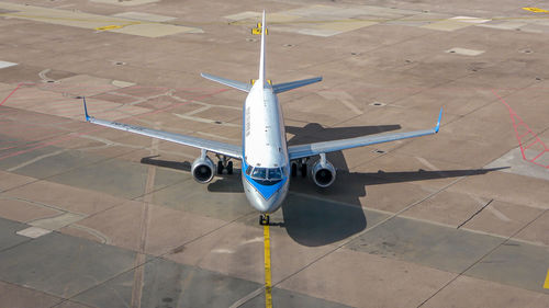 High angle view of airplane on airport runway