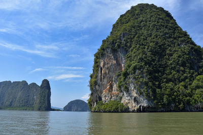 Rock formations by sea against sky