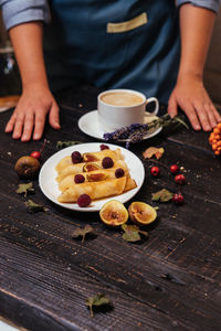 Midsection of woman preparing food on table