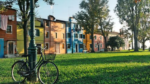 Bicycle by house against sky