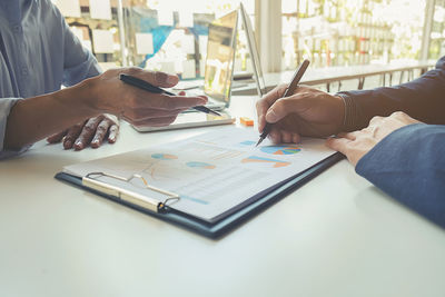 Close-up of people working in office
