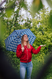 Full length of woman standing in rain