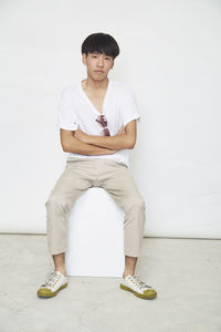 Portrait of smiling man standing against white background