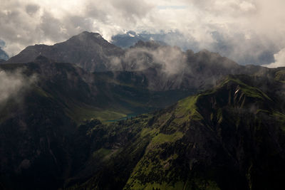 Scenic view of mountains against cloudy sky