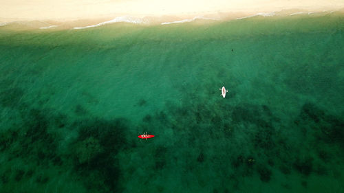 High angle view of people swimming in sea