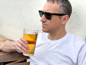 Middle aged man drinking beer in cafe or restaurant pub outdoor drinking alcohol lager or ale candid