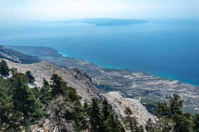 High angle view of sea and mountains against sky