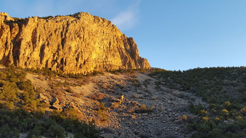 Rock formations on landscape against sky