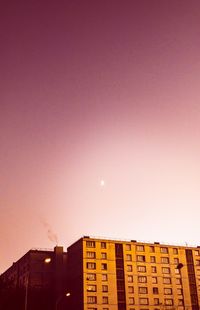 Low angle view of buildings against sky at dusk