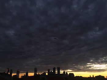 Low angle view of silhouette city against sky during sunset