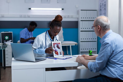 Doctor showing medical anatomy in digital tablet