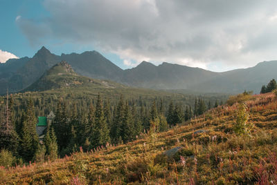 Scenic view of mountains against cloudy sky